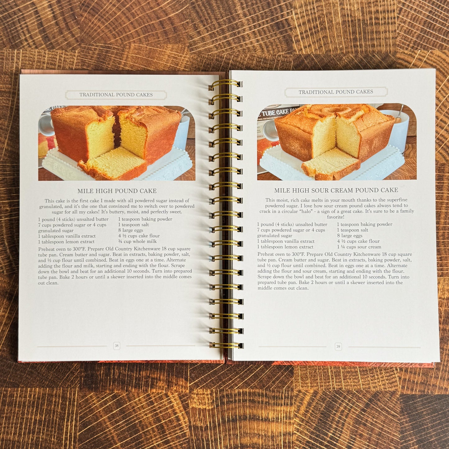Open cookbook on a wooden surface with recipes for pound cakes.